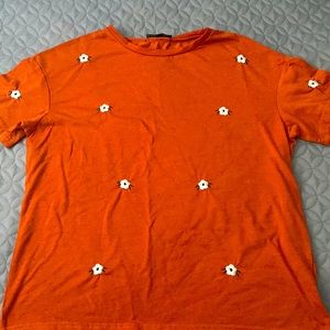 orange flowered shirt